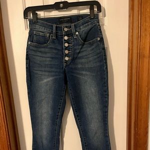 Lucky Brand sz 0 button fly ripped jeans with tattered ankles. Never worn